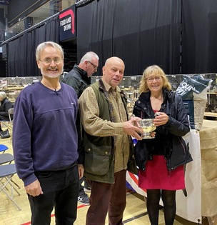 Malcolm Ford and partner Jennifer Huxtable receiving a cup for best black fantail from the Fantail Club president, Roy Baker.