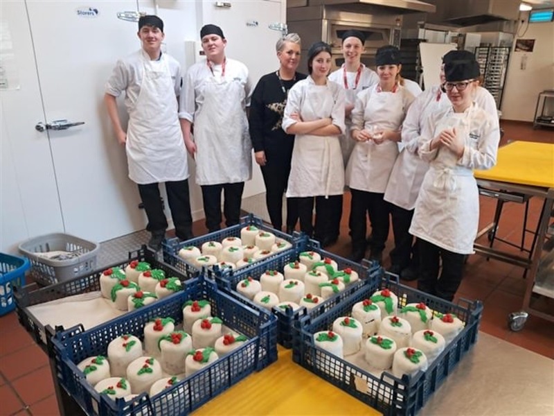 Nicola Thomson-Dewey and catering students with the Christmas cakes they have made for The Christmas dinner for care leavers Barnsley.