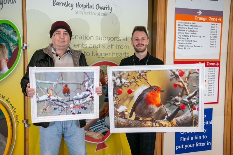 ROCKIN ROBIN: Photographer Darren Green, presents two stunning images to the Hospital charities Sam Bentley, the prints will form part of a fundraiser when they are auctioned off. Picture Shaun Colborn PD093797