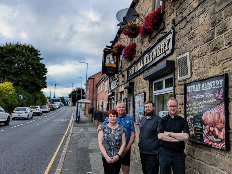 Licensees Paul and Julie Kenworthy with Barnsley CAMRA chair Andrew Taylor and Fr Blair Radford.