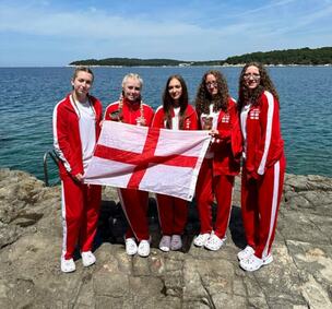 Left to right - Lucie Roberts, Lucy Frudd, Elisia McCaslin, Ella Tingle and Chloe Tingle holding an England flag in Croatia
