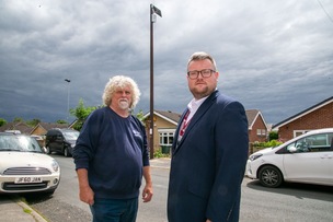 POLES APART: Phil Waller with Coun James Higgingbottom and the pole, on his front drive. Picture: Shaun Colborn PD093242