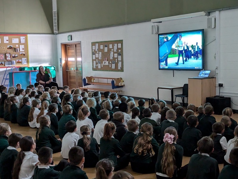 Children at Lacewood Primary watching the music video.