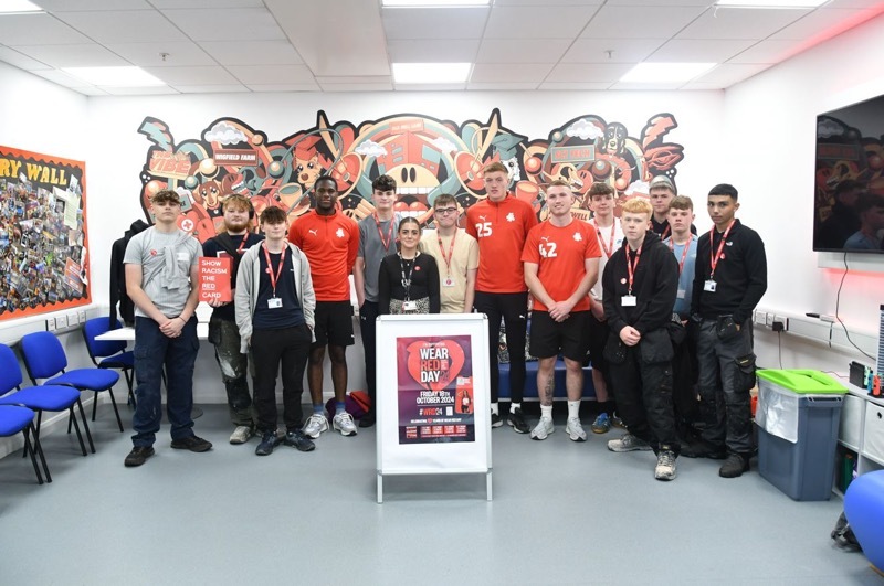 WEAR IT RED: Barnsley College students with Barnsley FC u21 players.