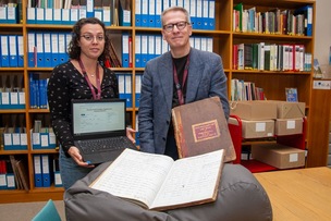 ONLINE: Thousands of files uploaded archivists Katy Best and James Stevenson with some of the ledgers that have now been digitised, and can now be viewed at most libraries. Picture Shaun Colborn PD093440