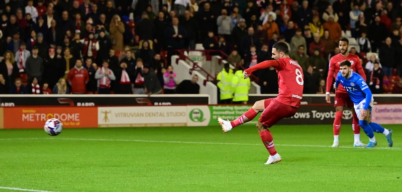 Adam Phillips scores his penalty