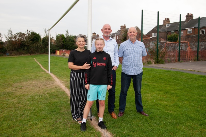 NEW POSTS: A set of new posts paid for by business man, Mark Bocum from Aspire Fabrications, has replaced ones cut down by the council, pictured are Jasmine Holt from the Hoyland common residents group, and Coun Andy Wray, along with local footballers. Picture Shaun Colborn PD093450