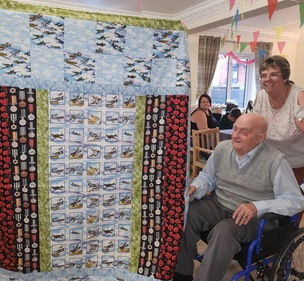 Deangate Care Home resident Maurice Churchouse, 94, with a commemorative quilt from Happy Hare