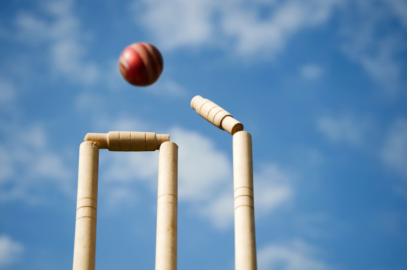 Cricket ball knocking wicket Stock Image